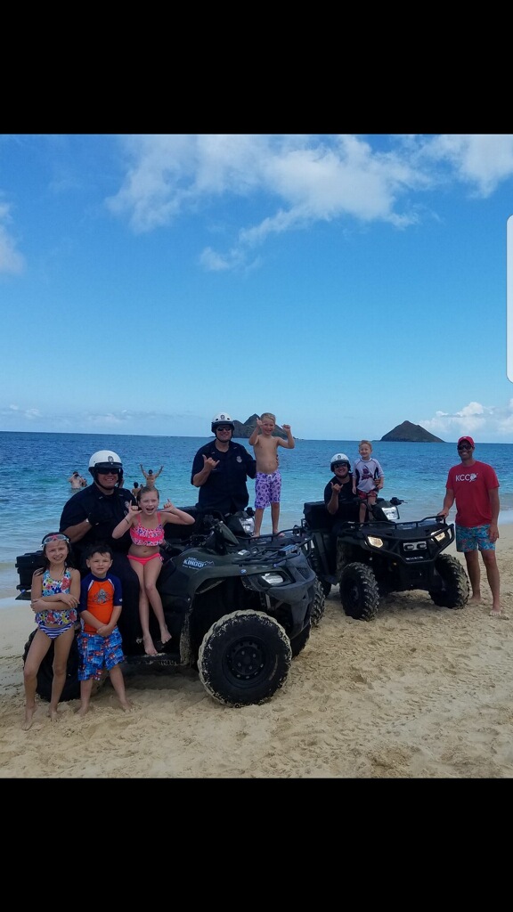 Picture of three ATV Honolulu Police Officers with beach goers