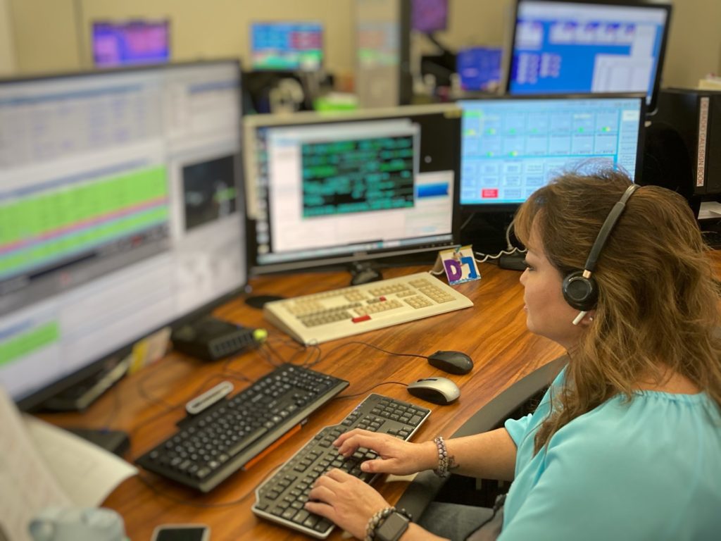 Photo of a HPD Radio Operator at her work station