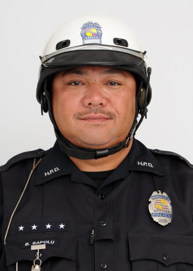 id photo of Solo Bike Officer Bill Sapolu dressed in his class A uniform and motorcycle helmet