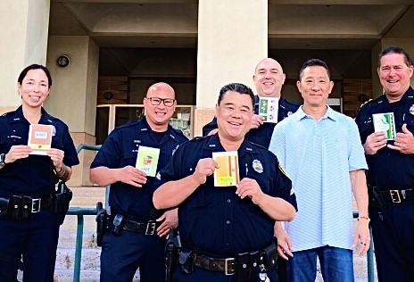 District 7 officers pose with handmade thank you cards from the Hawaii Kai Lions Club