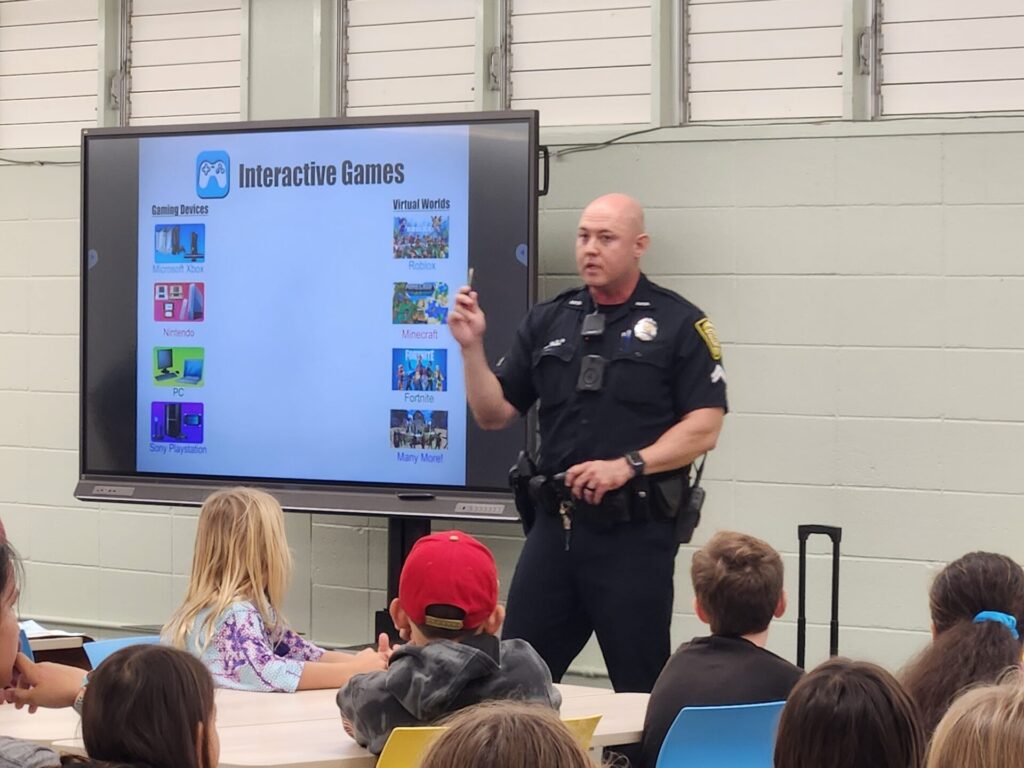 Officers informing students on how to be safe using the internet