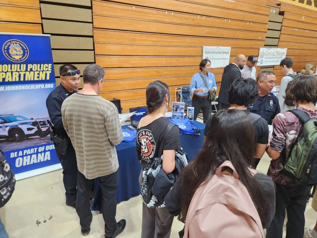 Officers at a career fair event at Mililani High School