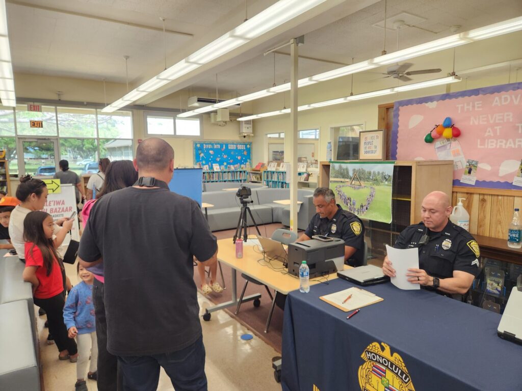 Officers providing free keiki id to students