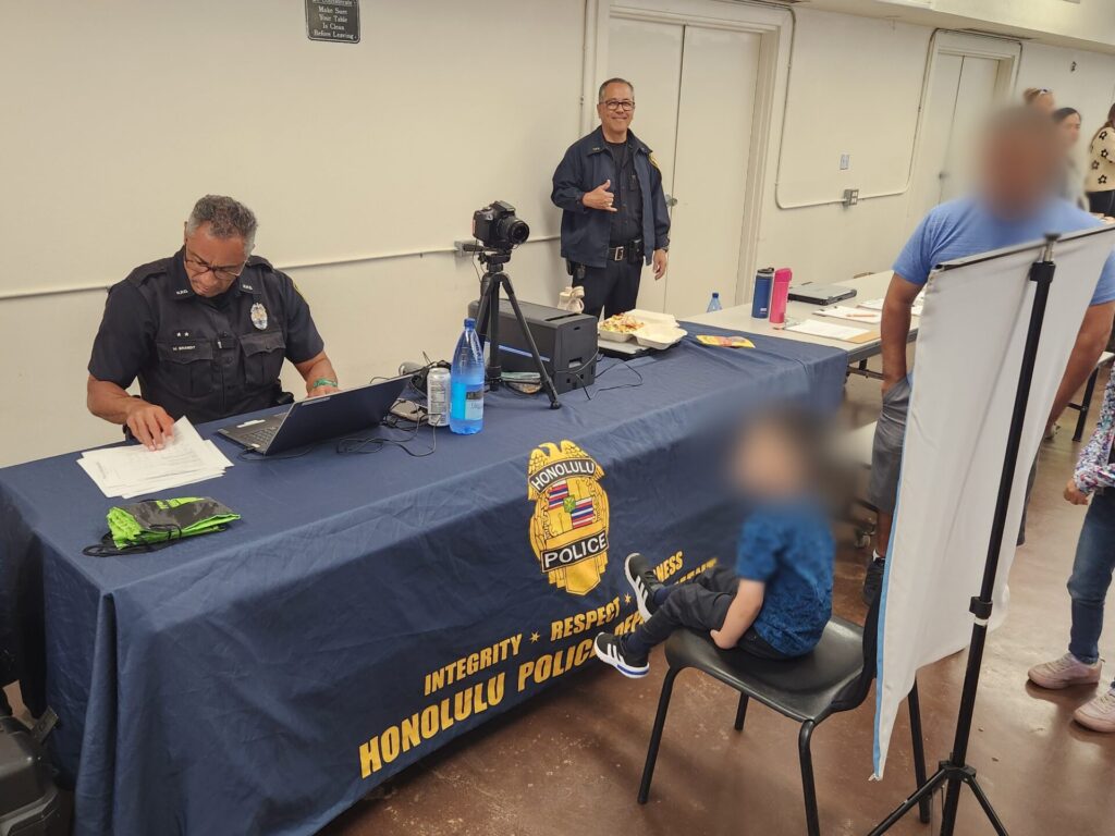 Officers making Keiki ID at the Wahiawa Middle School community fair