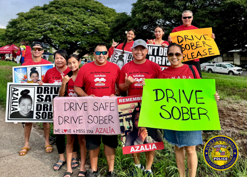 Traffic Division Honors Azalia Park with Sign-Waving and Checkpoint. Over the weekend, officers from the Traffic Division partnered with SafeRide Hawaiʻi, MADD Hawaiʻi, and the Keiki Injury Prevention Coalition Hawaiʻi for a sign-waving event in remembrance of Azalia Park, a victim of impaired driving in December 2020. Officers then conducted a sobriety checkpoint in the area, where sober drivers were thanked with a gift from MADD Hawaiʻi for choosing to drive sober. 🚗💙 Remember, making good decisions affects us all and helps ensure safer roads for everyone. 🌟 #SaferRoadsTogether #DriveWithAloha #SafeEveryMile