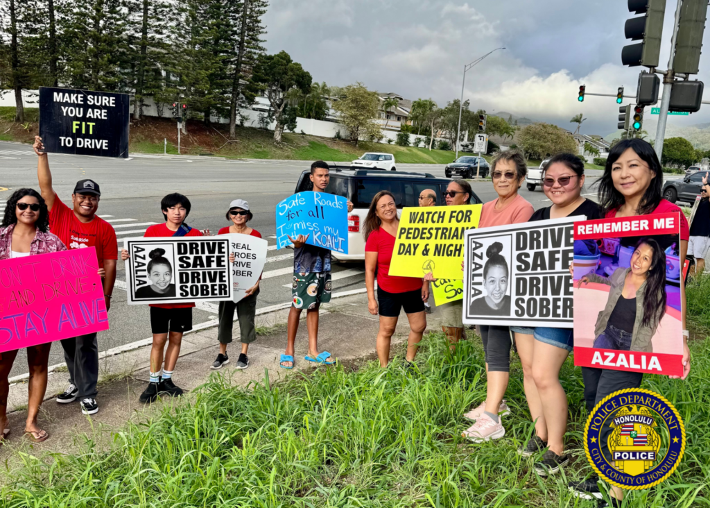 Traffic Division Honors Azalia Park with Sign-Waving and Checkpoint. Over the weekend, officers from the Traffic Division partnered with SafeRide Hawaiʻi, MADD Hawaiʻi, and the Keiki Injury Prevention Coalition Hawaiʻi for a sign-waving event in remembrance of Azalia Park, a victim of impaired driving in December 2020. Officers then conducted a sobriety checkpoint in the area, where sober drivers were thanked with a gift from MADD Hawaiʻi for choosing to drive sober. 🚗💙 Remember, making good decisions affects us all and helps ensure safer roads for everyone. 🌟 #SaferRoadsTogether #DriveWithAloha #SafeEveryMile