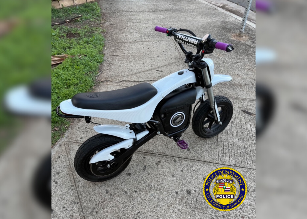 Photo of a white colored electric motorcycle/dirt-bike.