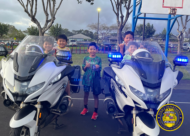 Children posing with HPD motorcycles