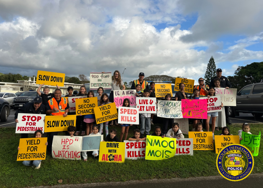 Group photo consisting of HPD officers an staff and students from an elementary school