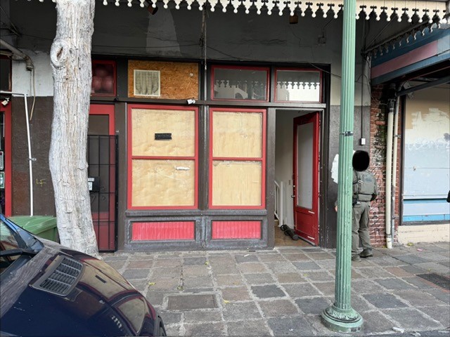 Business front of an illegal gambling scene. There is an open doors and window panes.