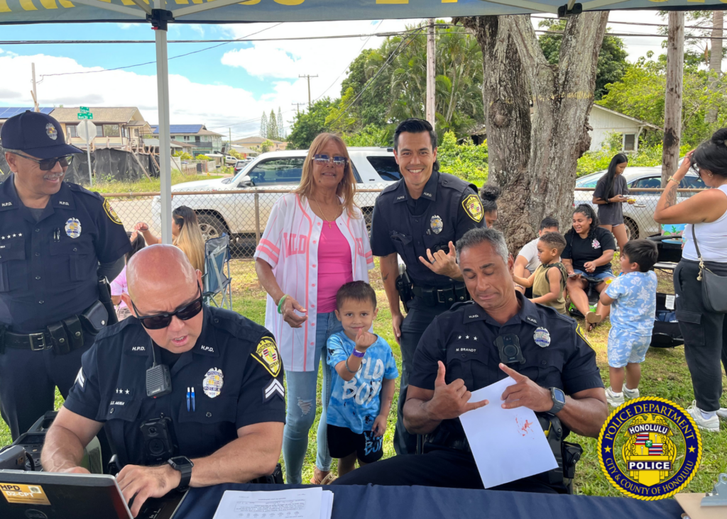 HPD officers and community members posing for a photo.