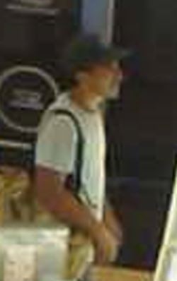 Unknown male suspect wearing a cap-style hat captured on surveillance camera