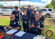 A group of Honolulu Police Department officers, a student intern from Mililani High School, and community members are posing together for a photo.