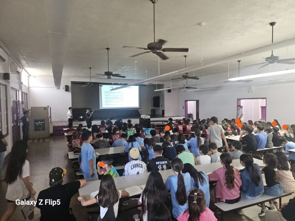 HPD Officers providing a crime prevention presentation to students.
