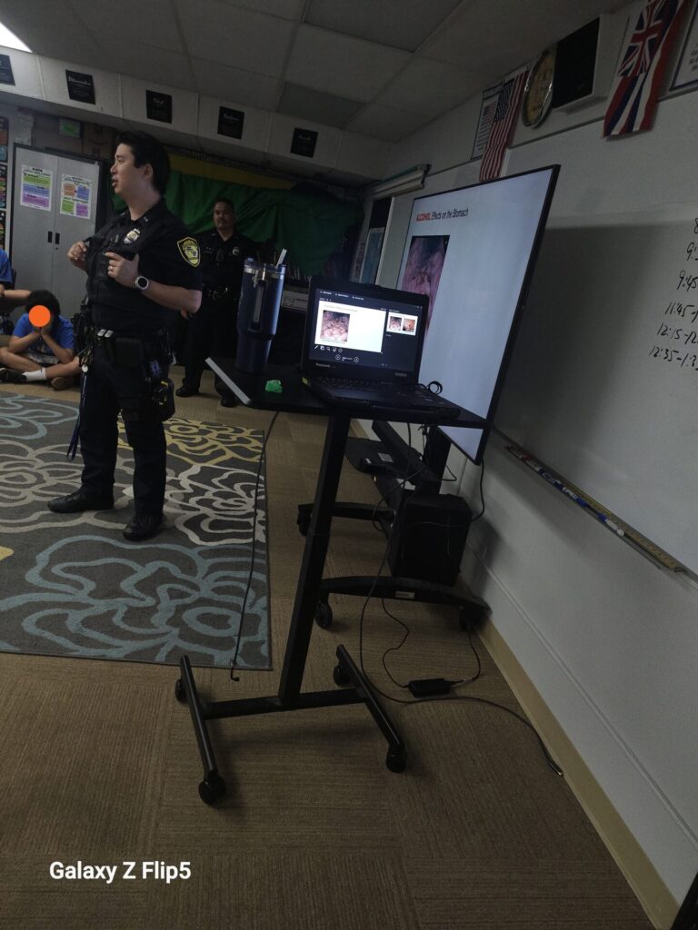 HPD Officers providing a safety presentation to students.