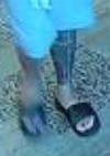 Unknown male with a chin strap fade beard and full tattoo on left lower leg shown on surveillance camera