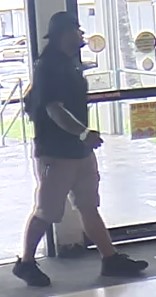 Unknown male suspect with a large build and prominent wristwatch on right arm shown on surveillance camera