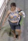 Unknown female with extensive tattoos across upper chest and right arm shown on surveillance video