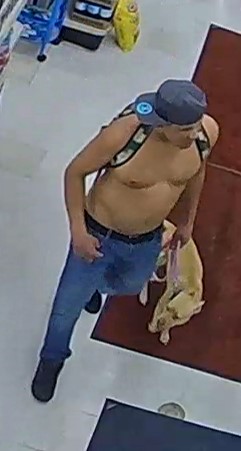 Unknown shirtless male with a leashed dog and unknown female carrying a sling bag captured on surveillance camera