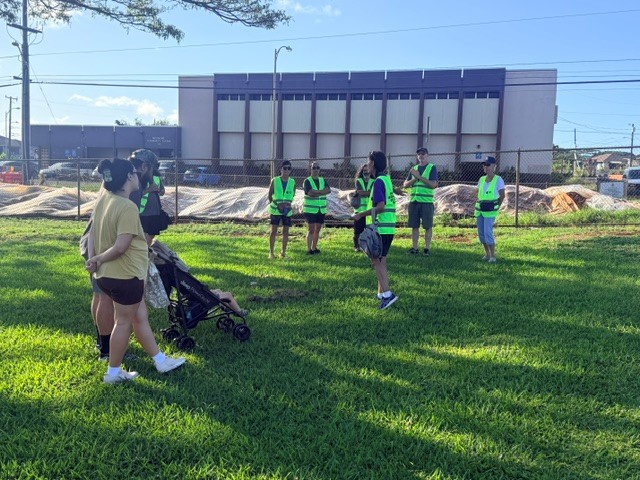 Officers and residents participate in a Citizen Patrol Walk to show presence in Whitmore Village