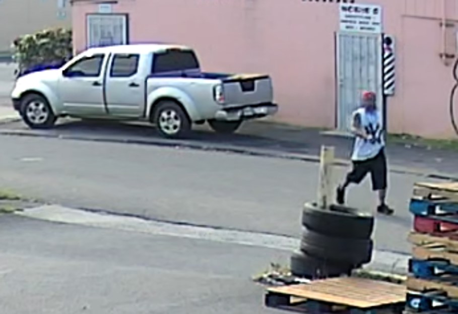 Unknown male wearing a backwards baseball cap and NY Yankees tank top as shown on surveillance camera