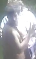 Unknown shirtless male and unknown female with reading glasses as shown on surveillance camera