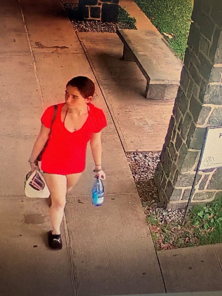 Unknown female wearing black socks and Puma slides as shown on surveillance video