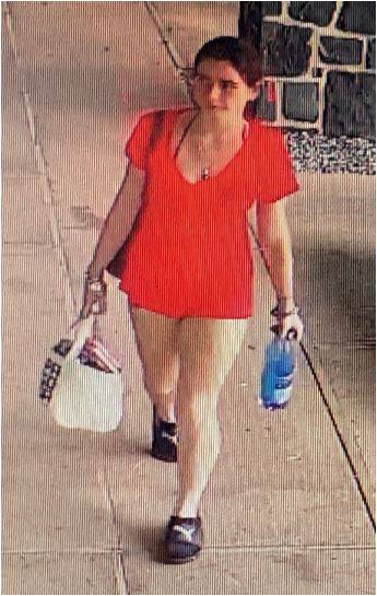 Unknown female wearing black socks and Puma slides as shown on surveillance video