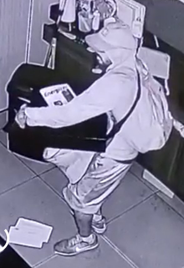 Unknown male suspect with tattoos on right shin and hand as shown on surveillance camera