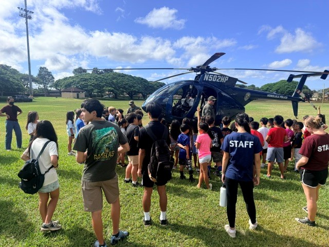 Officers explaining the role of the Police Helicopter/Pilot to Mililani Summer fun students