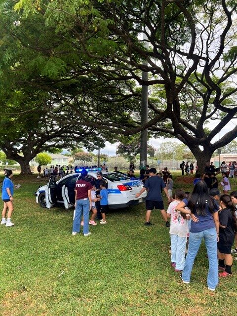 Officers showing the keiki the patrol vehicle at Mililani Summer fun. Keiki were able to sit in the back and ask questions regarding the vehicle