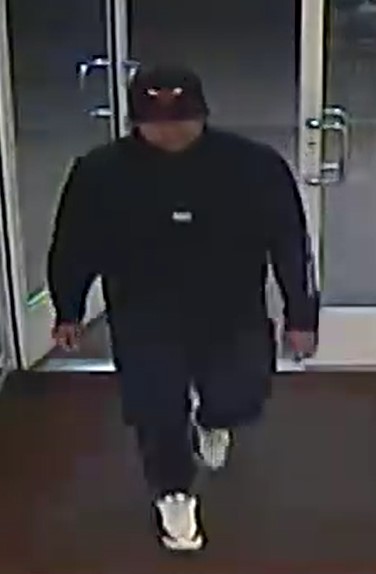 Unknown male wearing a sweatshirt, long athletic pants, and a Chicago Bulls hat as shown on surveillance camera