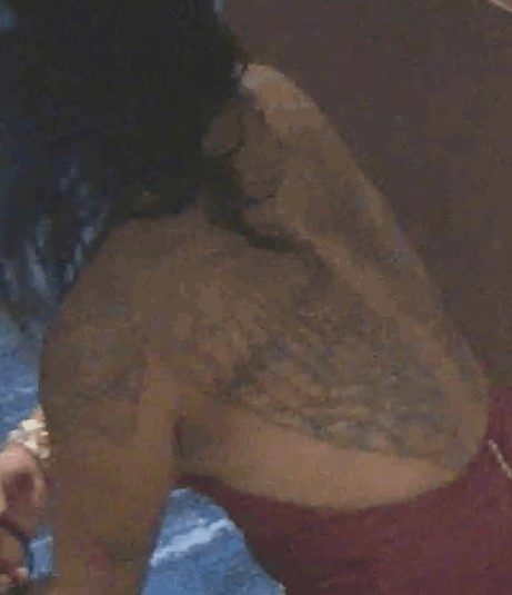 Barefoot individual in a halter-style backless dress as shown on surveillance camera