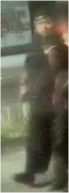 Unknown male wearing a backwards baseball cap and a rattail hairstyle as shown on surveillance camera
