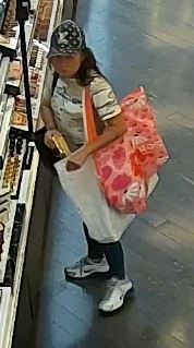 Unknown female suspect with a black and white Louis Vuitton hat and white athletic shoes as shown on surveillance camera