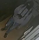 Unknown male wearing a ski mask as shown on surveillance camera.