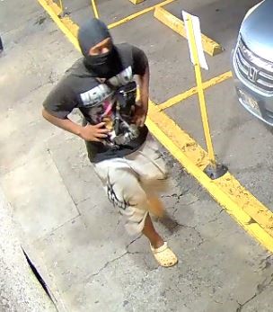 Unknown male suspect with a Nike brand balaclava and tribal graphic print shorts as shown on surveillance camera
