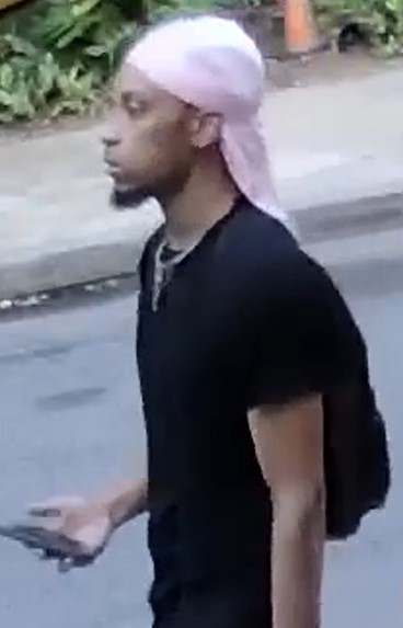 Unknown male suspect with a dark goatee and sideburns, wearing a durag as shown on surveillance camera