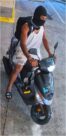Unknown male suspect on a black moped with stickers on the front above and below the headlight as shown on surveillance camera