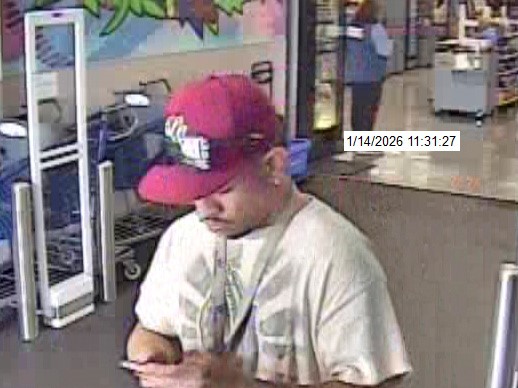 Unknown male suspect wearing a red NY Yankees cap and lanyard around his neck as shown on surveillance camera