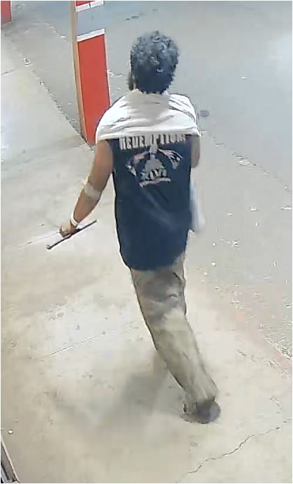 Unknown barefoot male suspect wearing a bath towel around his neck and medical wristband as shown on surveillance camera